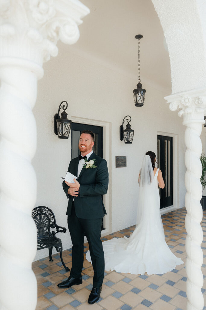 groom listening to personal vows at The Alderman House by Mizner
