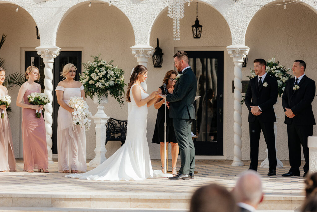 bride and groom at alter at The Alderman House by Mizner