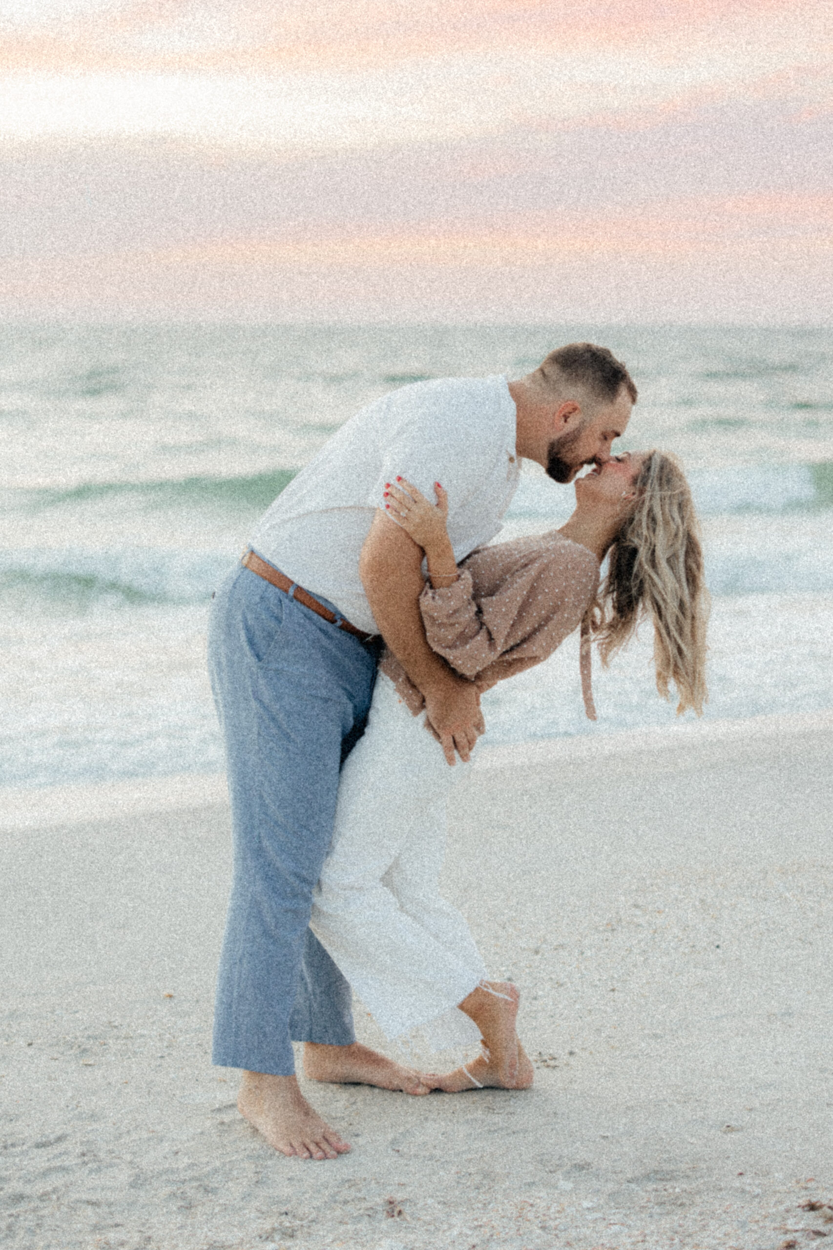engaged couple kissing during sunset in Boca Grande, Florida