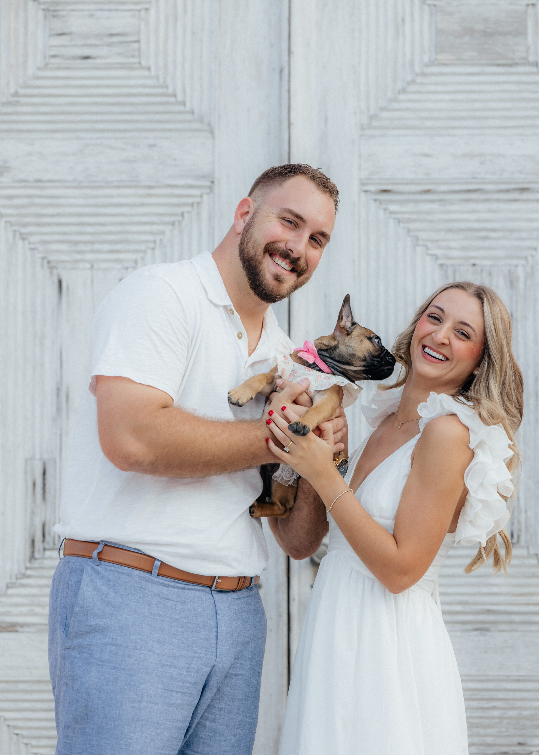 engaged couple holding their puppy in Boca Grande, Florida