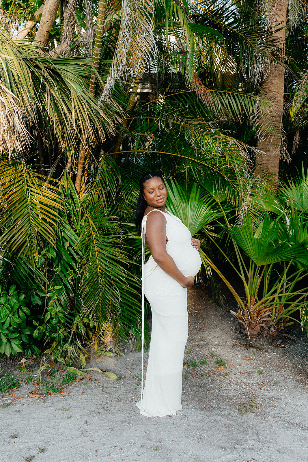 mom-to-be holding belly for maternity photoshoot in Southwest Florida