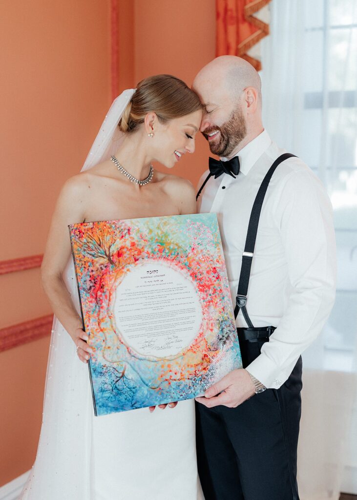 Bride and groom holding signed ketubah for Bay Preserve at Osprey wedding