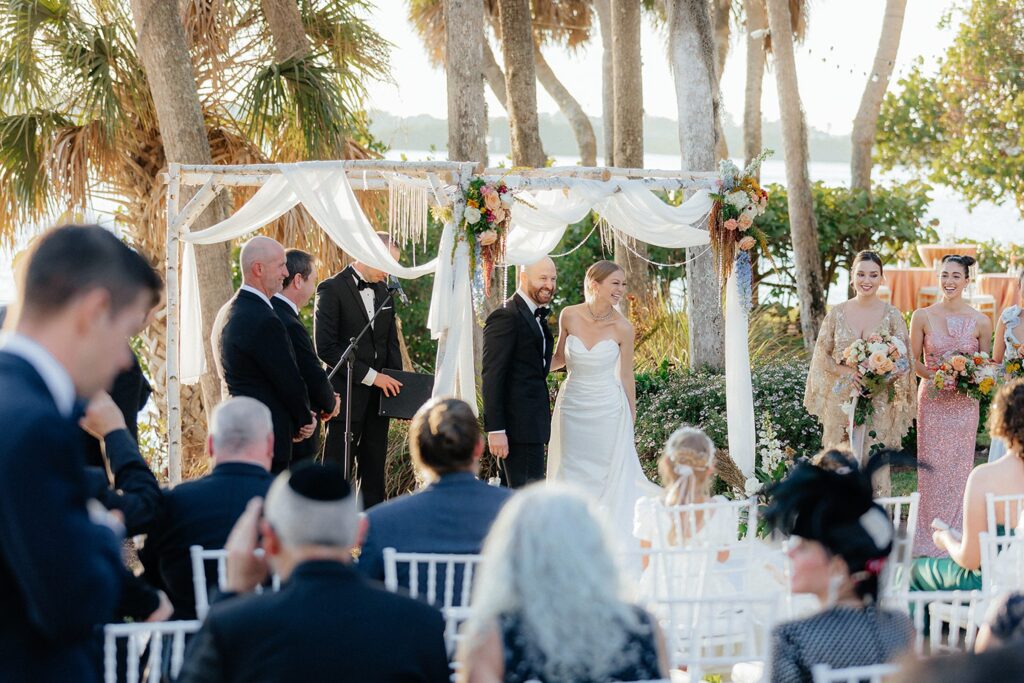 Bride and groom under chuppah for Florida wedding