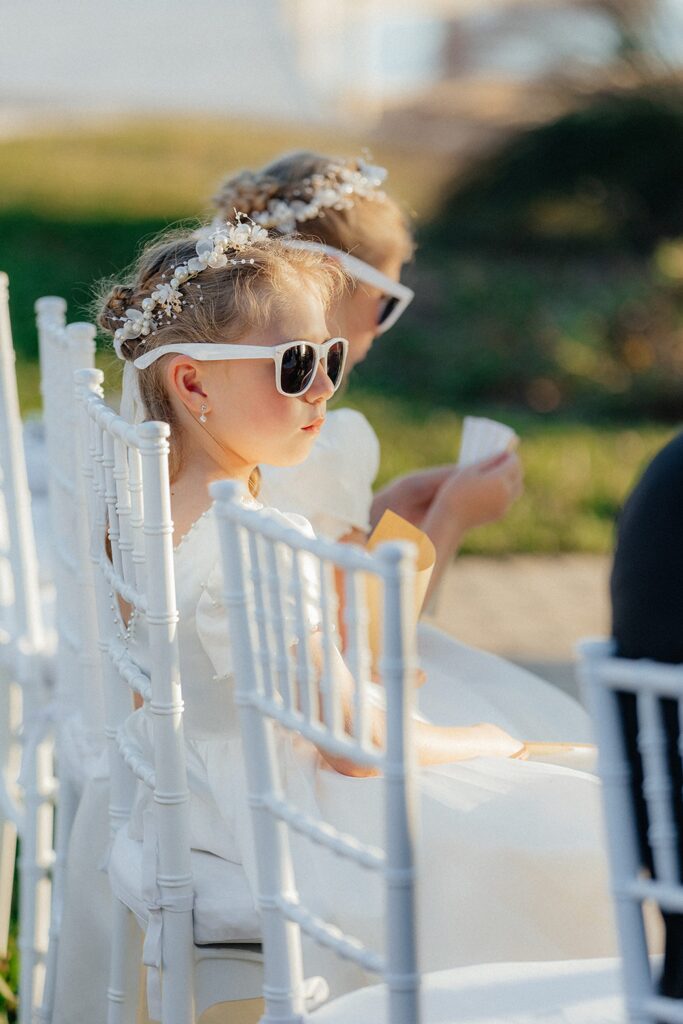 Flower girls with sunglasses during wedding ceremony