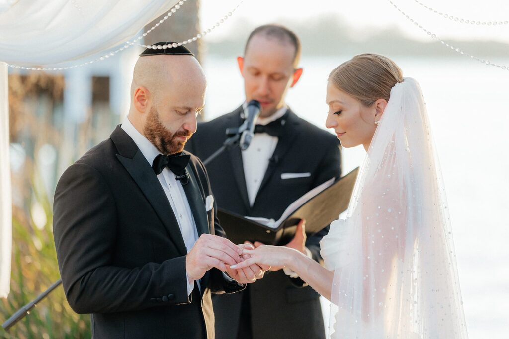 Bride and groom exchanging rings during traditional Jewish ceremony in Southwest Florida