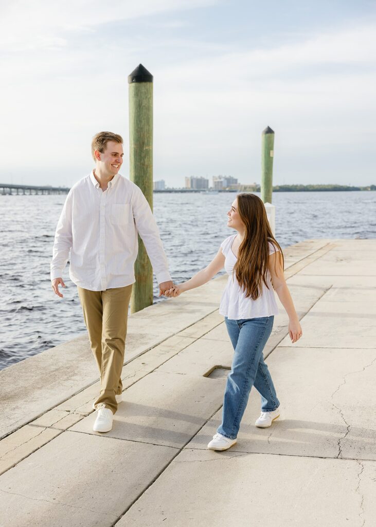 Couple walking hand in hand during Fort Myers engagement photos