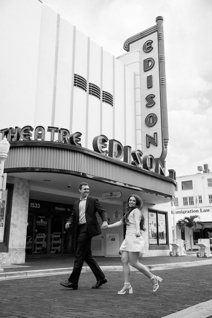 Black and white engagement photos in front of Theatre Edison in Fort Myers. 